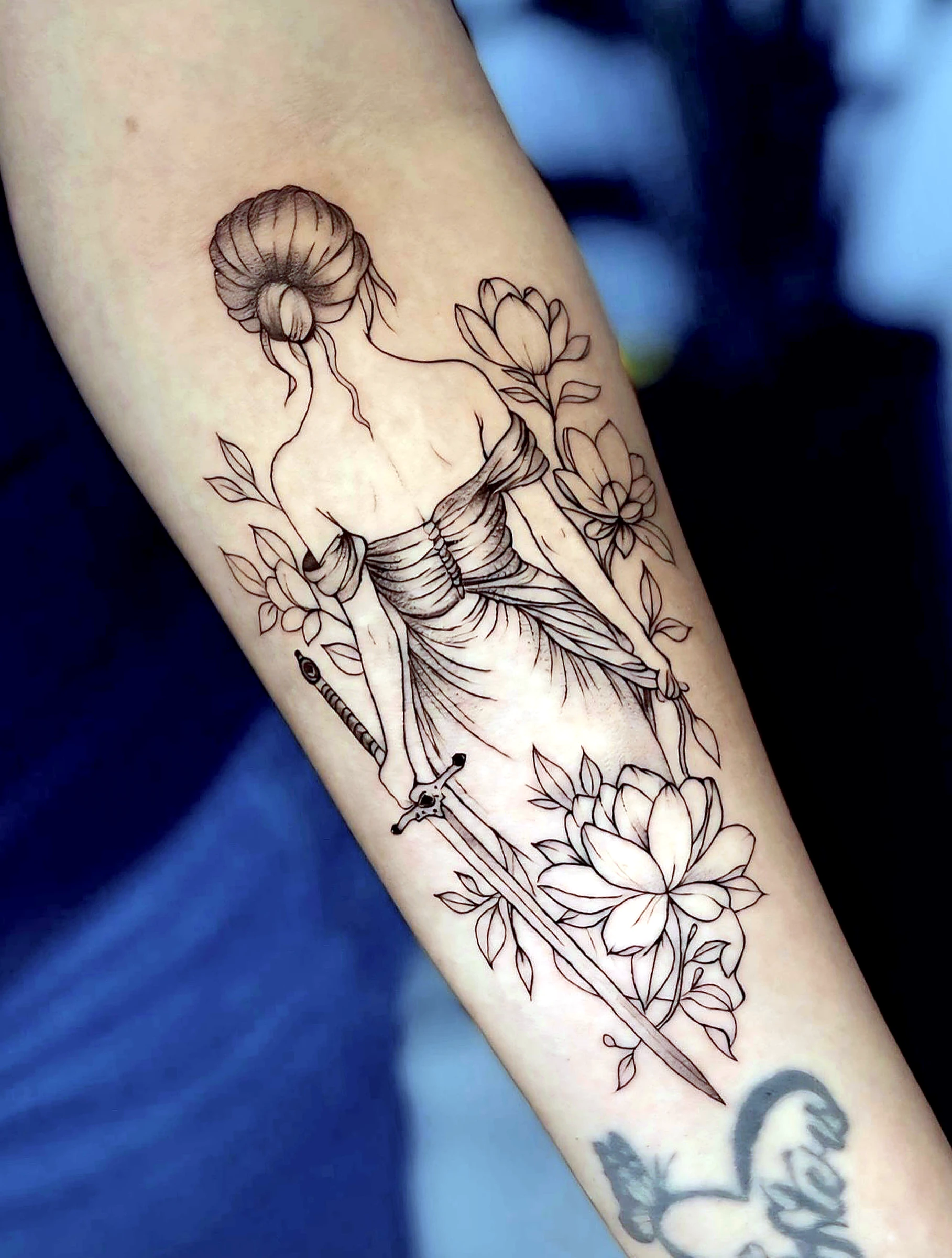 Black and grey realism floral statue with sword tattoo by Rav Singh at Inkology