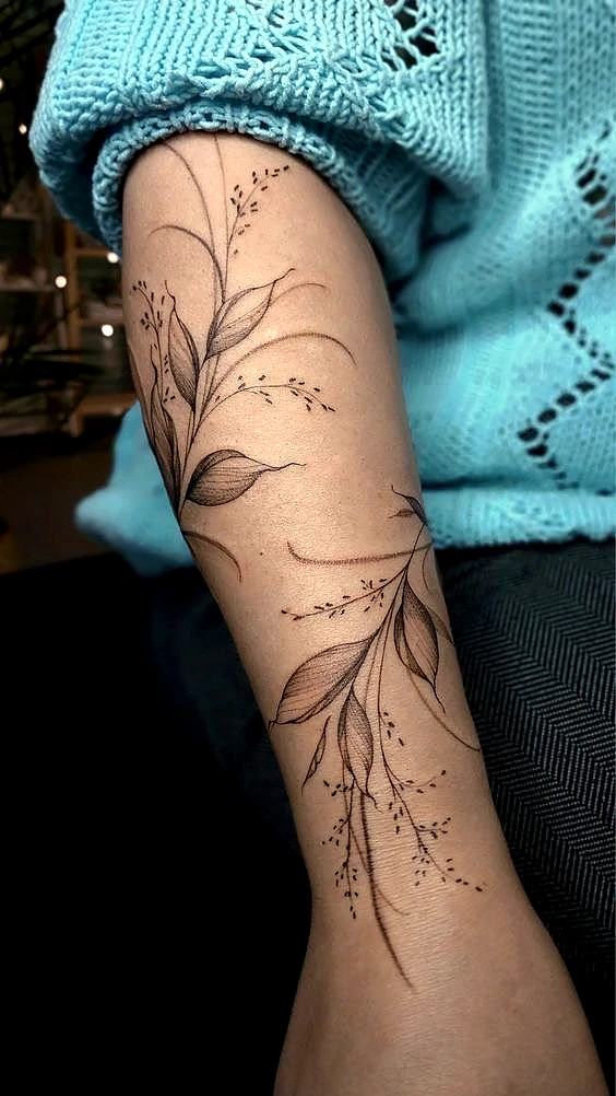Delicate fine line botanical tattoo on the forearm by Rav Singh at Inkology