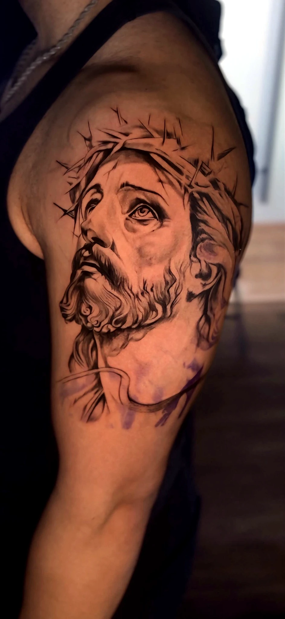 Black and grey realism Jesus with crown on the shoulder by Rav Singh at Inkology